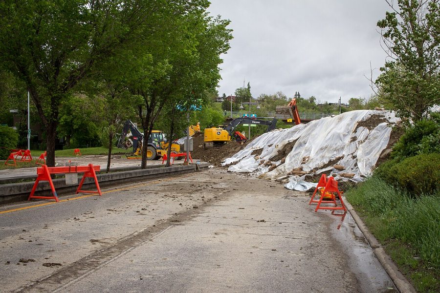 Workers construct a berm along the Bow river in anticipation of flooding in Calgary